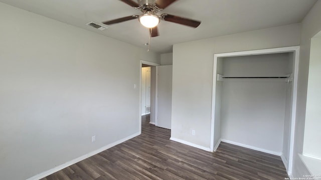 unfurnished bedroom featuring ceiling fan, a closet, and dark wood-type flooring