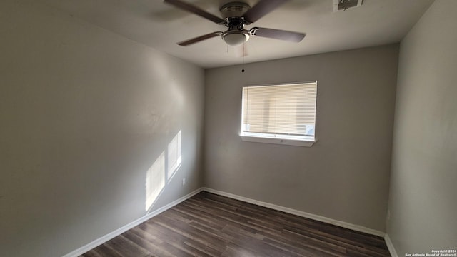 empty room with ceiling fan and dark wood-type flooring