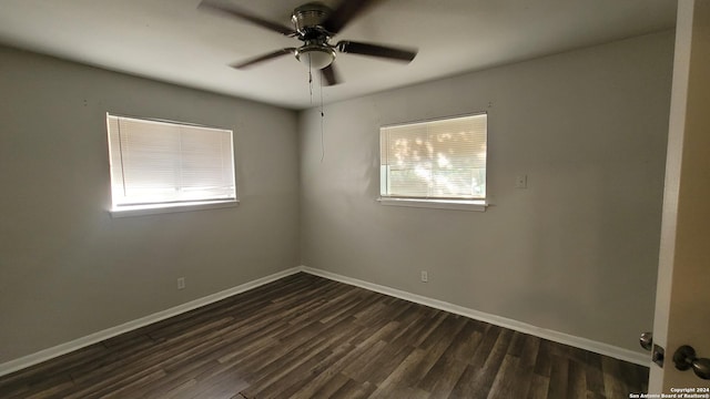 spare room with ceiling fan and dark wood-type flooring