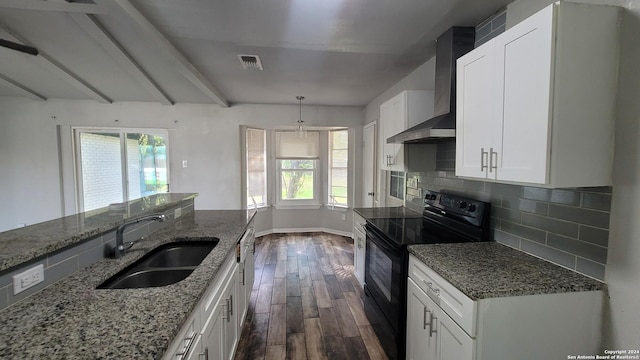 kitchen with a wealth of natural light, sink, wall chimney exhaust hood, black range with electric cooktop, and white cabinets