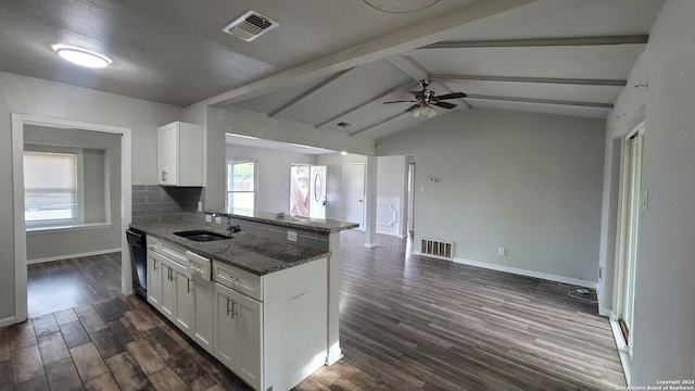 kitchen featuring lofted ceiling with beams, white cabinetry, dark wood-type flooring, and dark stone counters