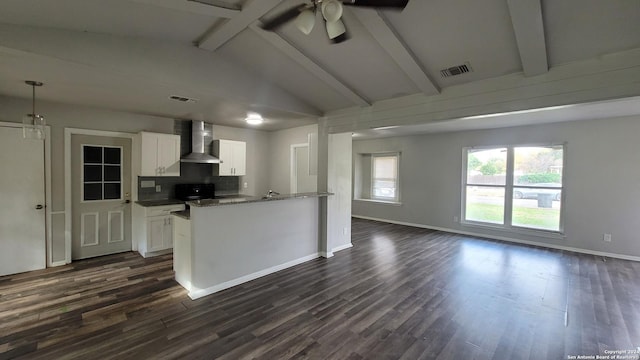 kitchen featuring white cabinetry, ceiling fan, wall chimney exhaust hood, dark hardwood / wood-style flooring, and lofted ceiling with beams