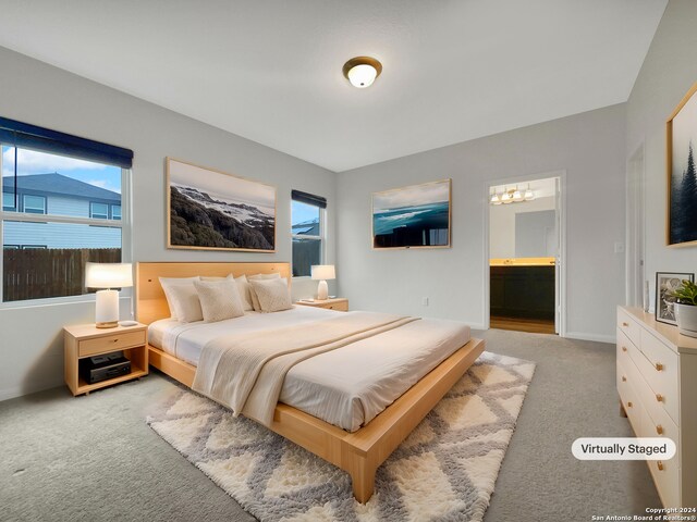 carpeted bedroom featuring ensuite bath