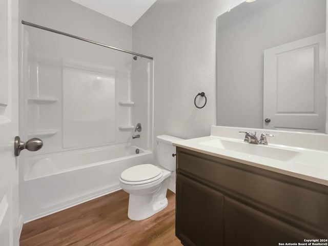 full bathroom featuring hardwood / wood-style floors, vanity, toilet, and shower / bathtub combination