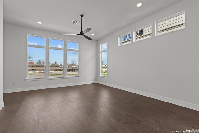 spare room with ceiling fan and dark wood-type flooring