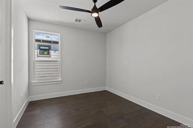 unfurnished room featuring dark hardwood / wood-style floors and ceiling fan