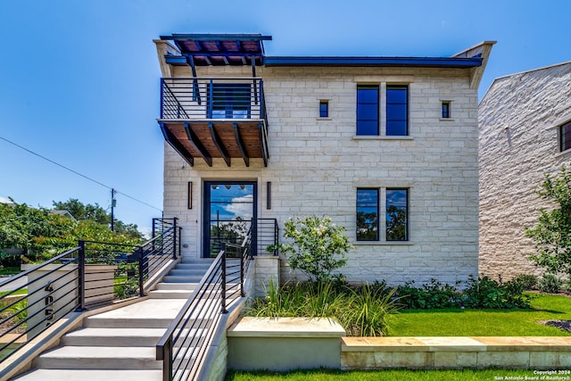 view of front of property with a balcony