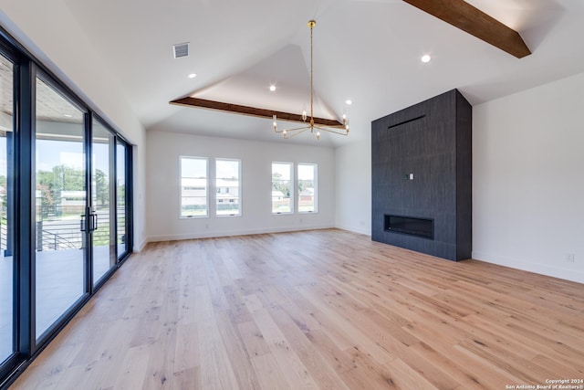 unfurnished living room featuring high vaulted ceiling, light hardwood / wood-style floors, a fireplace, beam ceiling, and a chandelier