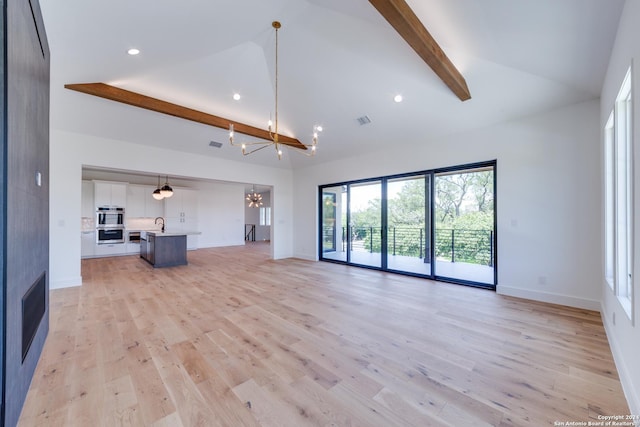 unfurnished living room with sink, high vaulted ceiling, light hardwood / wood-style flooring, beamed ceiling, and a chandelier