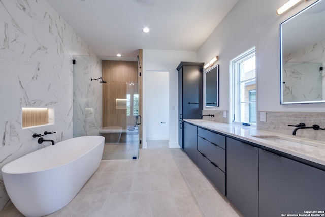 bathroom with tile patterned flooring, vanity, separate shower and tub, and tile walls