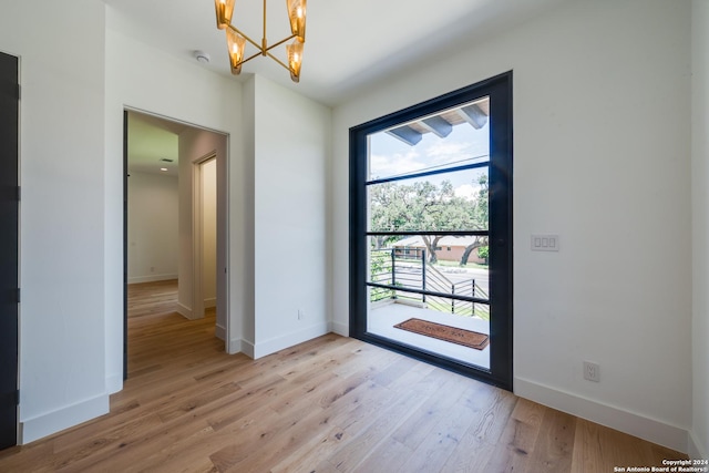 entryway featuring light hardwood / wood-style floors and an inviting chandelier