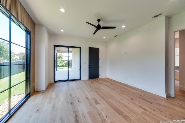 empty room with light hardwood / wood-style flooring and ceiling fan