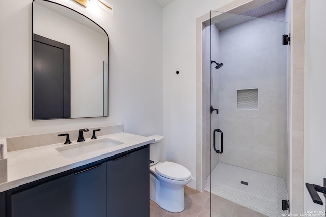 bathroom with walk in shower, tile patterned flooring, vanity, and toilet