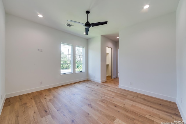 empty room with light hardwood / wood-style flooring and ceiling fan