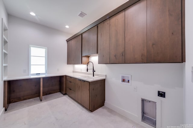 laundry room with hookup for an electric dryer, hookup for a washing machine, cabinets, and sink