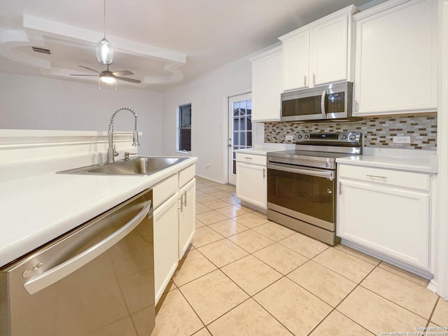 kitchen with sink, decorative backsplash, ceiling fan, white cabinetry, and stainless steel appliances