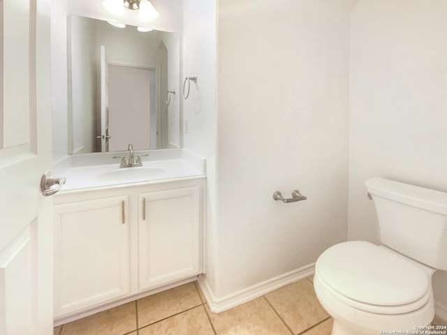 bathroom featuring tile patterned floors, vanity, and toilet