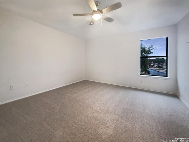 unfurnished room with ceiling fan and carpet floors