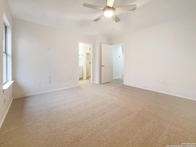 carpeted spare room featuring ceiling fan