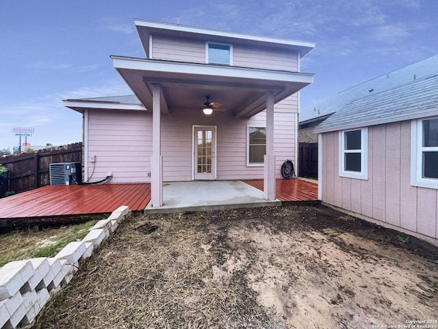 rear view of house with a deck, ceiling fan, cooling unit, and a patio area