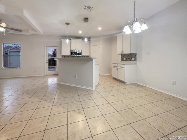 kitchen with backsplash, ceiling fan with notable chandelier, decorative light fixtures, light tile patterned flooring, and white cabinetry