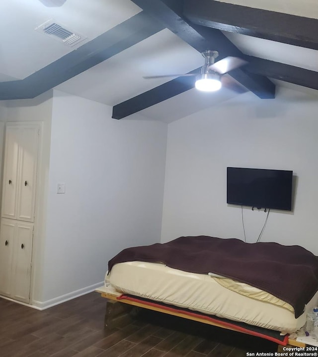 bedroom with beam ceiling, ceiling fan, and dark wood-type flooring