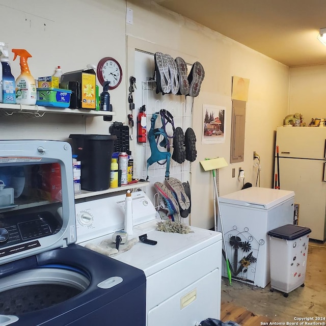 washroom featuring electric panel and washing machine and clothes dryer