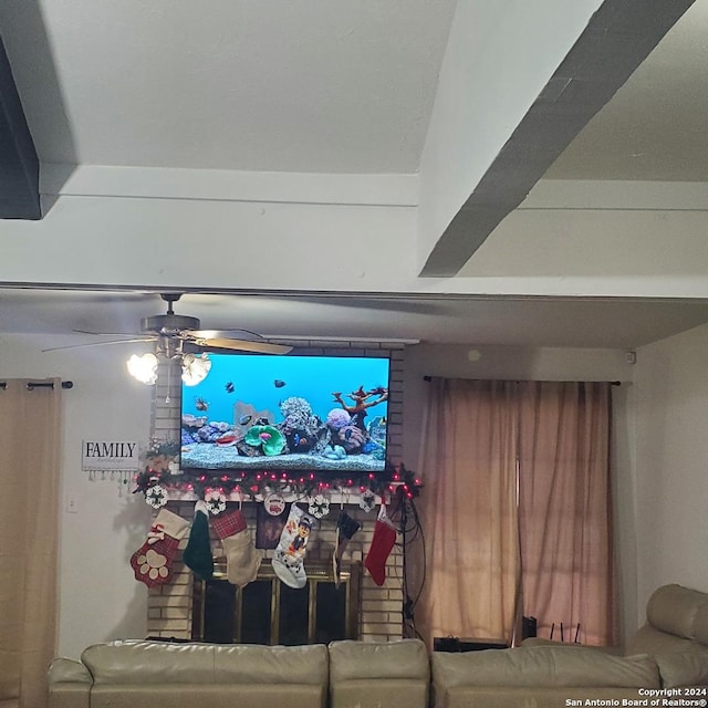 living room featuring ceiling fan and a fireplace