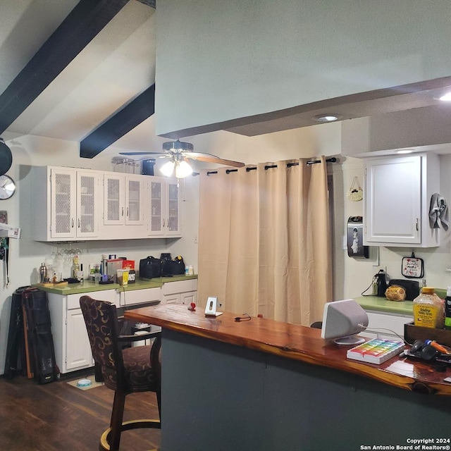 kitchen featuring beam ceiling, white cabinetry, dark hardwood / wood-style flooring, and ceiling fan