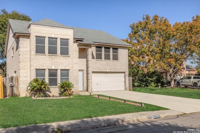 view of front of home with a front yard and a garage