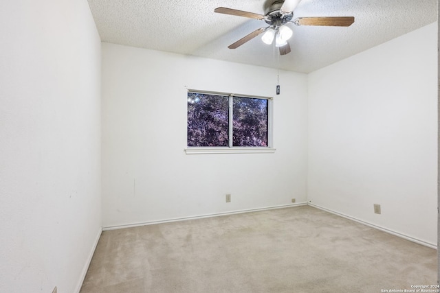 carpeted empty room with a textured ceiling and ceiling fan