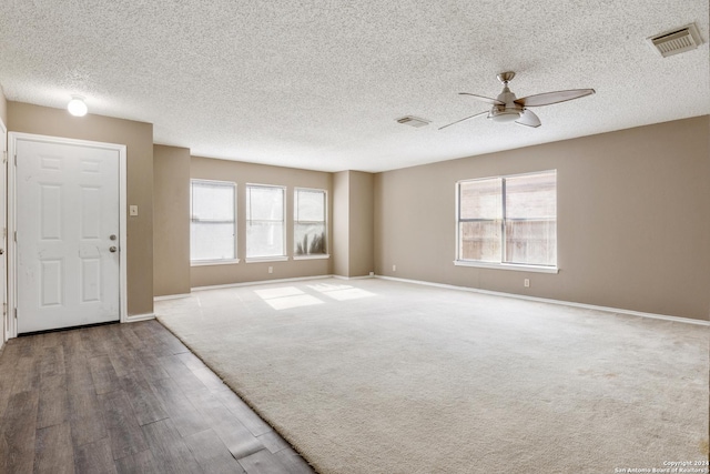 interior space featuring a textured ceiling, hardwood / wood-style flooring, and ceiling fan