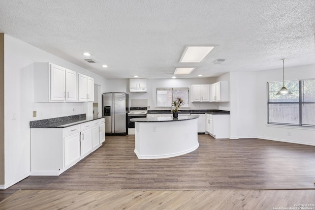 kitchen featuring a textured ceiling, white cabinetry, dark wood-type flooring, and appliances with stainless steel finishes