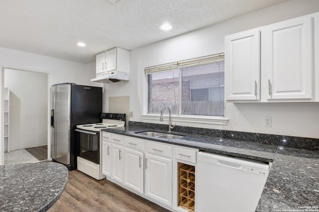 kitchen with white appliances, white cabinets, sink, hardwood / wood-style flooring, and a textured ceiling