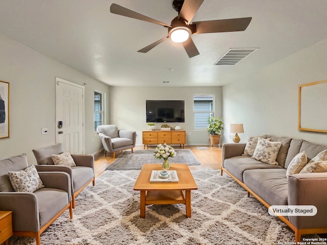 living room featuring ceiling fan and light hardwood / wood-style flooring