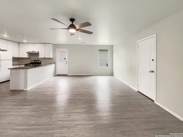 unfurnished living room with ceiling fan, light hardwood / wood-style floors, and sink