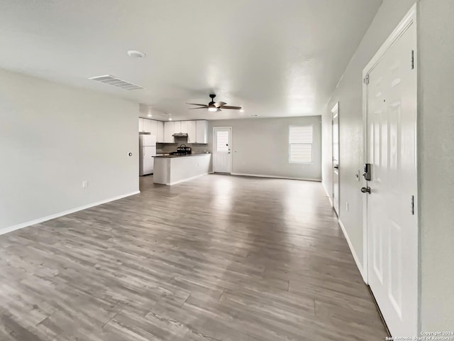 unfurnished living room featuring light wood-type flooring and ceiling fan