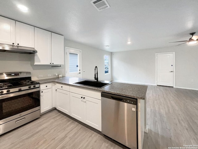 kitchen featuring white cabinetry, sink, light hardwood / wood-style floors, and appliances with stainless steel finishes