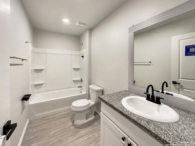 full bathroom featuring shower / bathing tub combination, vanity, hardwood / wood-style flooring, and toilet