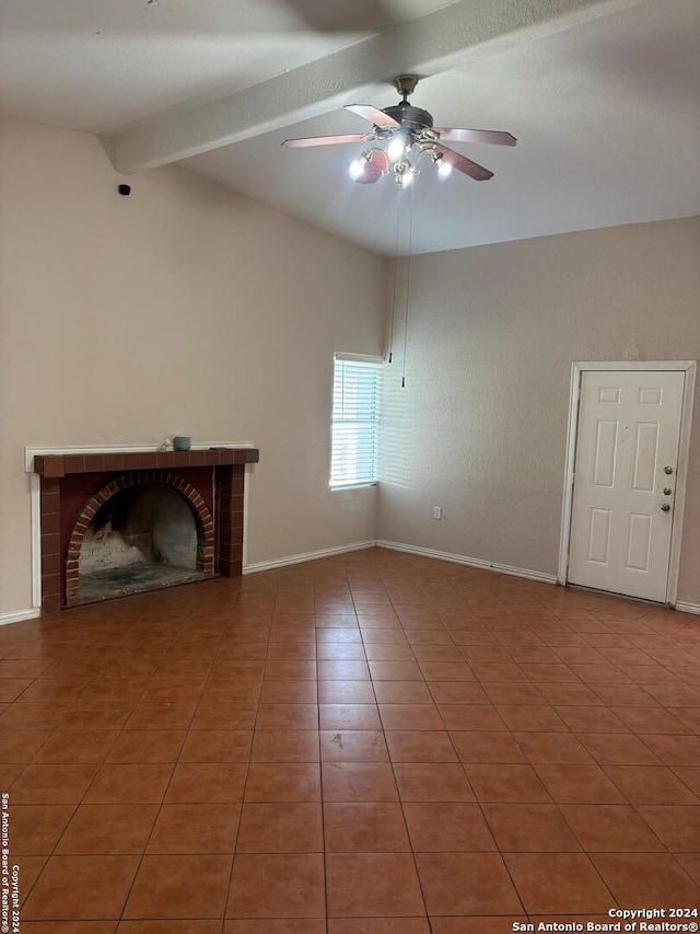 unfurnished living room with tile patterned floors, ceiling fan, lofted ceiling with beams, and a brick fireplace