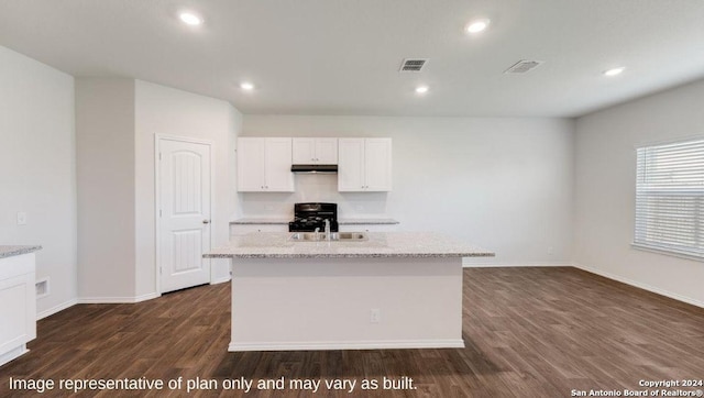 kitchen featuring dark hardwood / wood-style floors, white cabinetry, a kitchen island with sink, and light stone counters