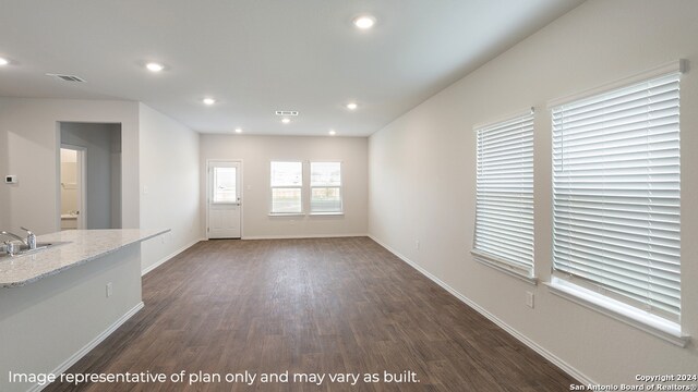 unfurnished living room with dark wood-type flooring