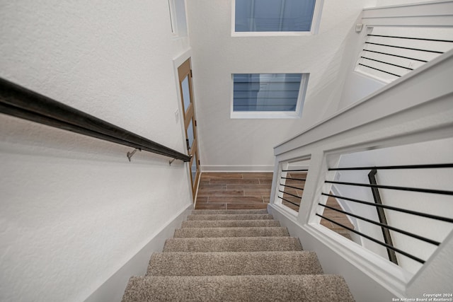 staircase with hardwood / wood-style floors