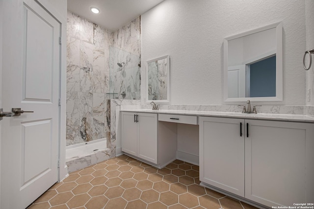 bathroom featuring tile patterned floors, a shower, and vanity