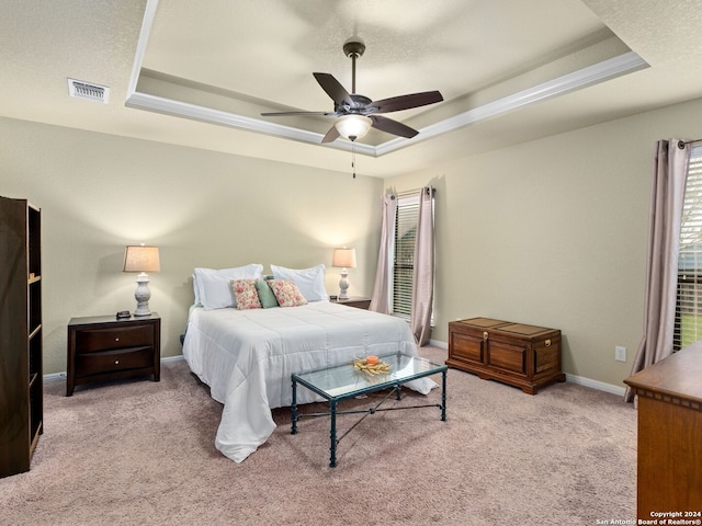 bedroom featuring a tray ceiling, ceiling fan, and light colored carpet