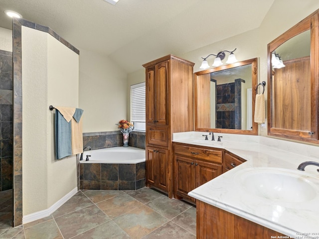 bathroom featuring vanity, vaulted ceiling, and shower with separate bathtub