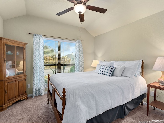 bedroom featuring light colored carpet, vaulted ceiling, and ceiling fan