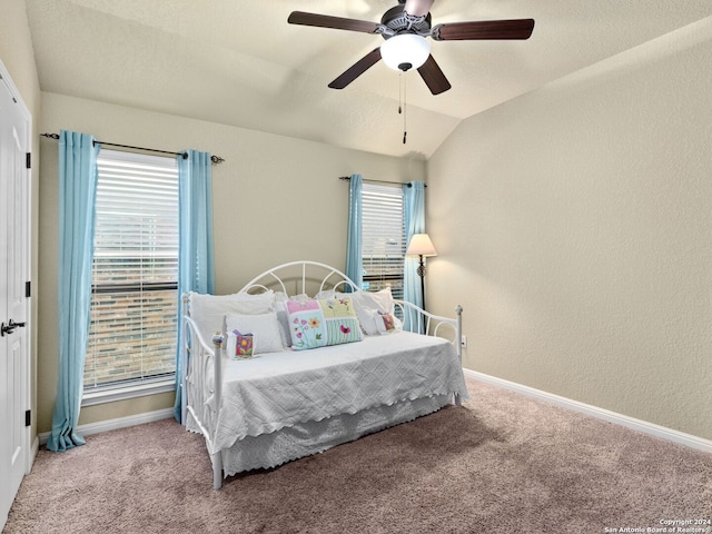 bedroom featuring light colored carpet, vaulted ceiling, and ceiling fan