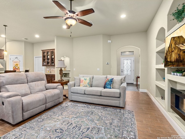 living room featuring hardwood / wood-style flooring and ceiling fan