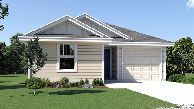 view of front of property featuring a front yard and a garage